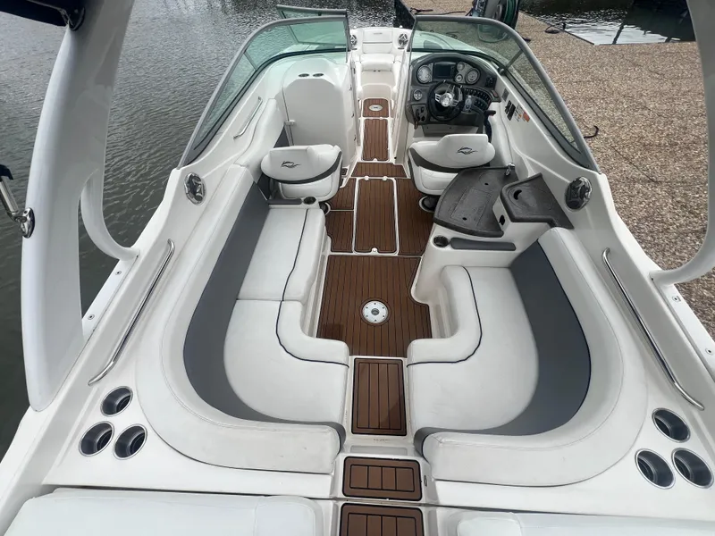 Slide: The Image of 2011 Rinker 276 Captiva Bowrider with spacious seating and sleek design on the water. - 18