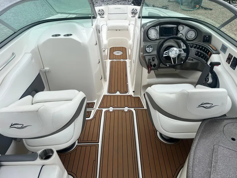 Slide: The Image of 2011 Rinker 276 Captiva Bowrider interior with white seating and wood-style flooring. - 20