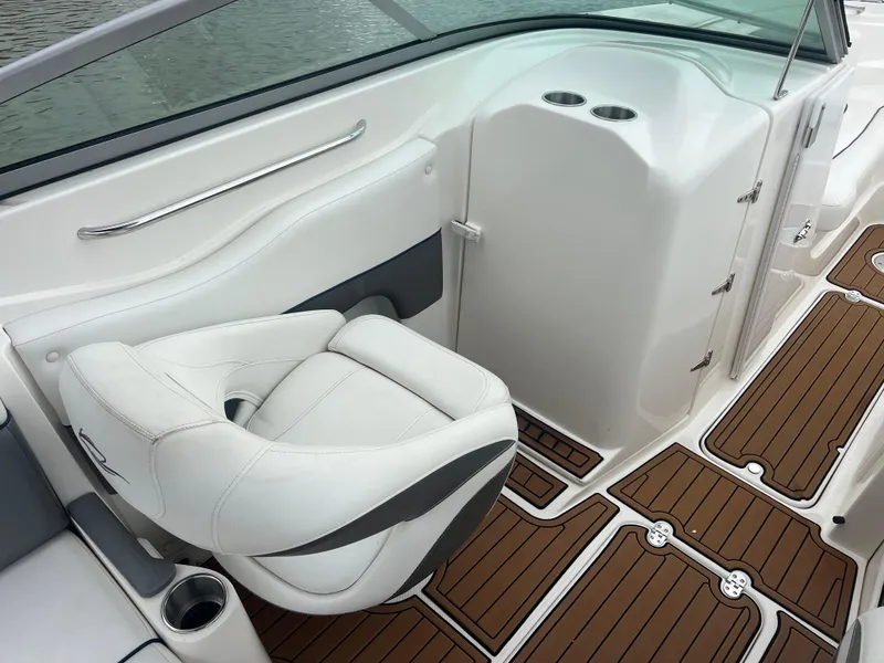 Slide: The Image of 2011 Rinker 276 Captiva Bowrider interior with white seating and wood-patterned flooring. - 21