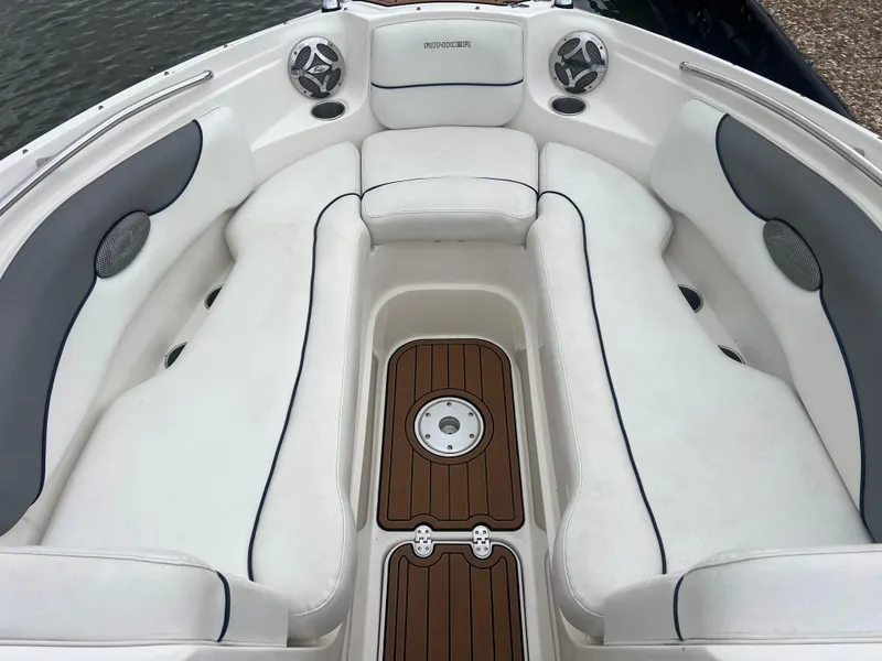 Slide: The Image of 2011 Rinker 276 Captiva Bowrider interior with white seating and wood accents. - 23