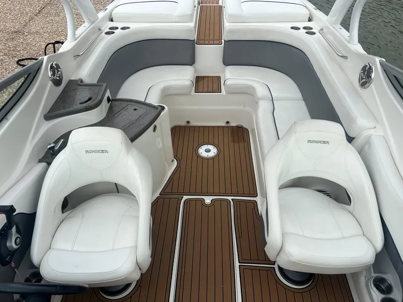 Slide: The Image of 2011 Rinker 276 Captiva Bowrider interior with white seating and wood flooring. - 24