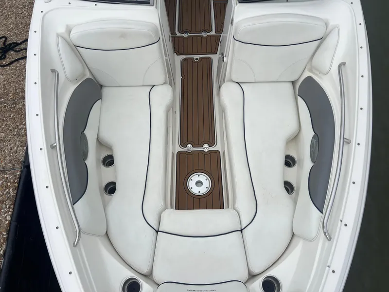 Slide: The Image of 2011 Rinker 276 Captiva Bowrider interior with white seating and wood accents. - 27