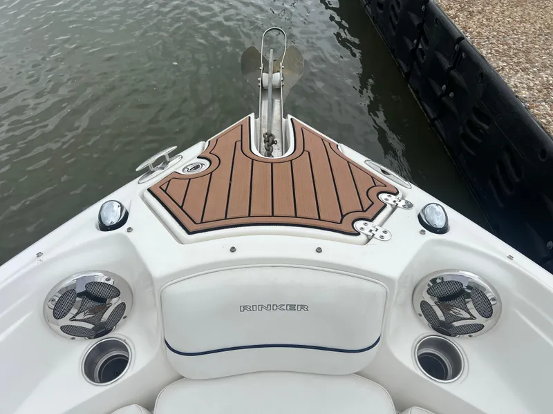Slide: The Image of 2011 Rinker 276 Captiva Bowrider boat bow with wood deck and speakers. - 29