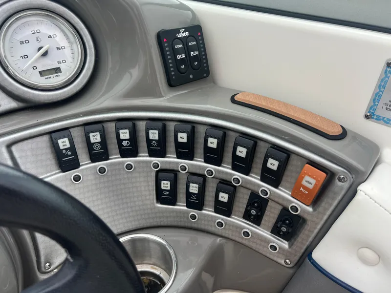 Slide: The Image of Control panel of a 2011 Rinker 276 Captiva Bowrider boat with various switches and gauges. - 30