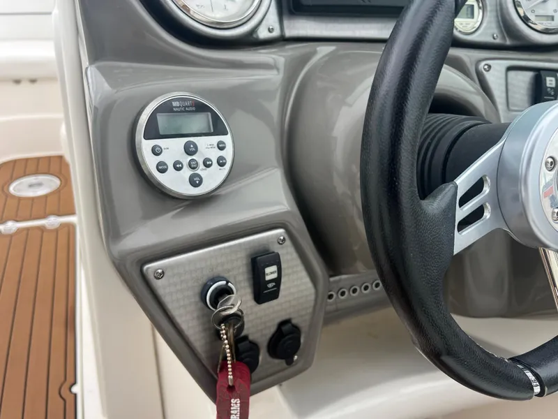 Slide: The Image of 2011 Rinker 276 Captiva Bowrider dashboard with steering wheel and control panel. - 31