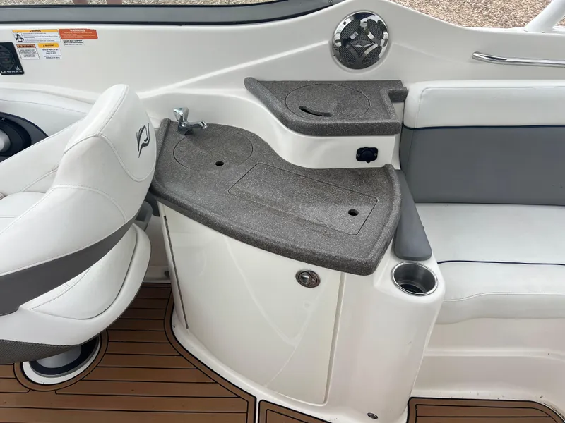 Slide: The Image of 2011 Rinker 276 Captiva Bowrider interior with seating and console details. - 34