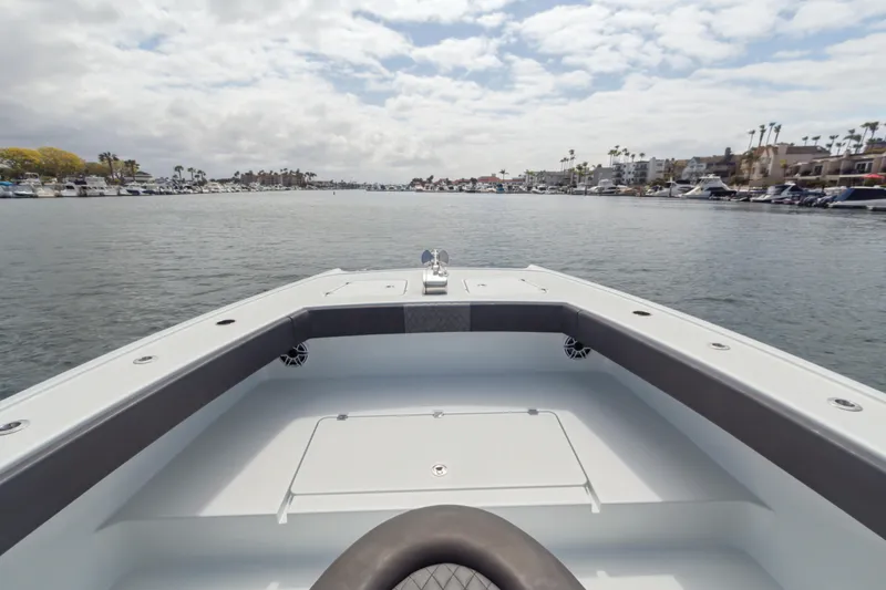 Slide: The Image of Bow view of 2022 Freeman 34VH boat on a calm waterway. - 10
