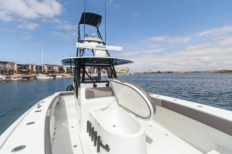 Slide: The Image of 2022 Freeman 34VH boat on water, open hatch, clear sky, waterfront homes in background. - 11