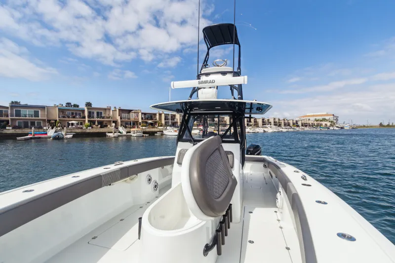 Slide: The Image of 2022 Freeman 34VH boat on water, with modern design and coastal background. - 12