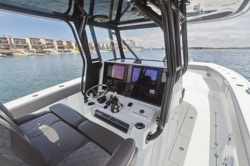 Slide: The Image of Interior view of 2022 Freeman 34VH boat with modern navigation system and waterfront backdrop. - 4