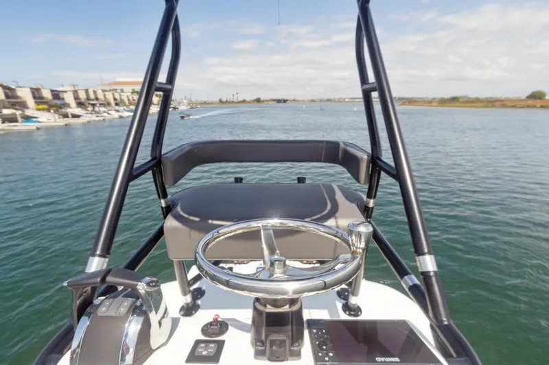 Slide: The Image of 2022 Freeman 34VH boat helm with steering wheel on calm water. - 6