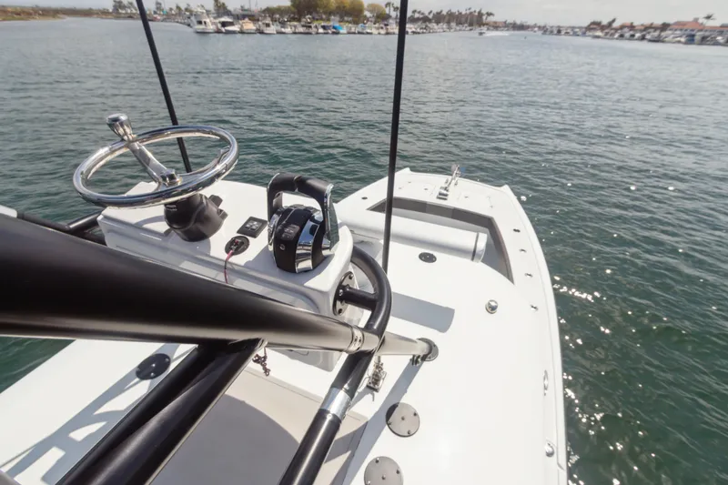 Slide: The Image of 2022 Freeman 34VH boat on water, featuring steering wheel and controls, with marina in background. - 8