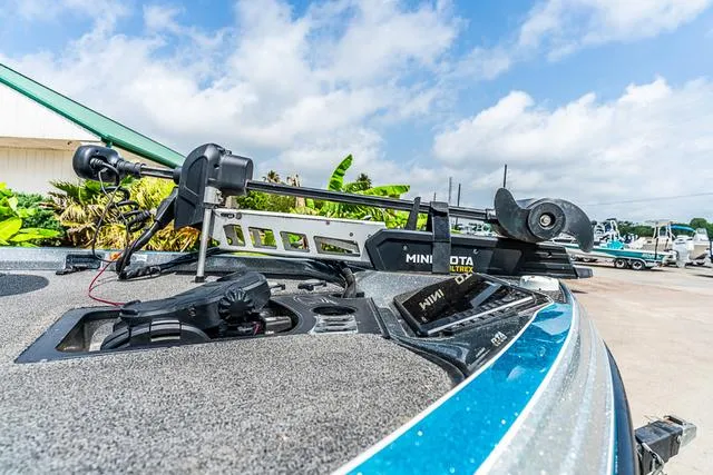 Slide: The Image of 2020 Ranger 521L boat with Minn Kota trolling motor, docked under a blue sky. - 11