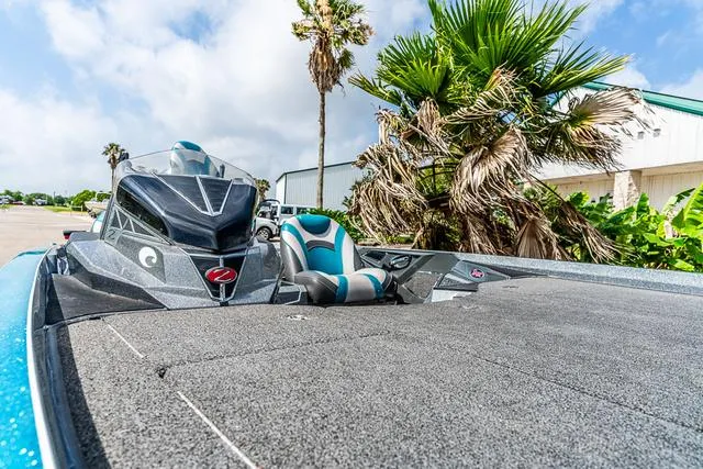 Slide: The Image of 2020 Ranger 521L boat with sleek design, parked near palm trees under a blue sky. - 12