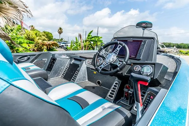 Slide: The Image of 2020 Ranger 521L boat cockpit with modern steering and navigation system, blue and gray seating. - 13