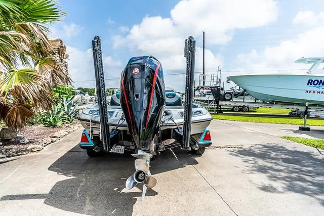 Slide: The Image of 2020 Ranger 521L boat with powerful outboard motor, parked on concrete driveway. - 4