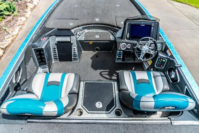 Slide: The Image of 2020 Ranger 521L boat interior with blue and gray seats, modern dashboard, and steering wheel. - 7