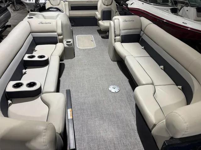 Slide: The Image of 2021 Barletta Boats C24uc interior with spacious seating and cup holders. - 3