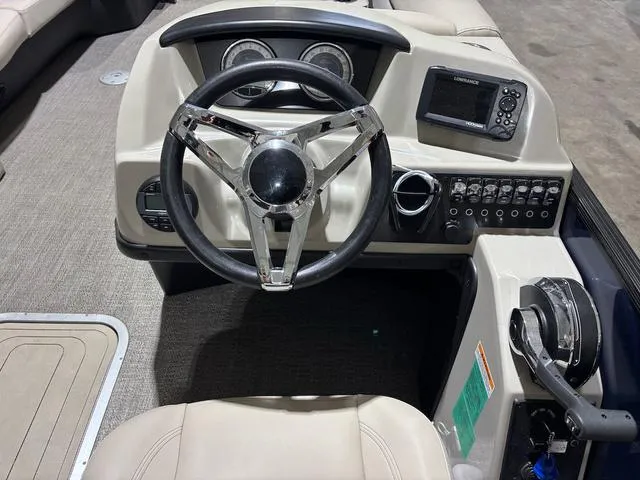 Slide: The Image of 2021 Barletta Boats C24uc dashboard with steering wheel and control panel. - 7