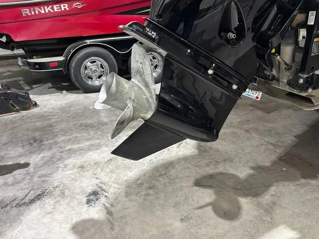 Slide: The Image of Outboard motor propeller of 2021 Barletta Boats C24uc, with a red Rinker boat in the background. - 9