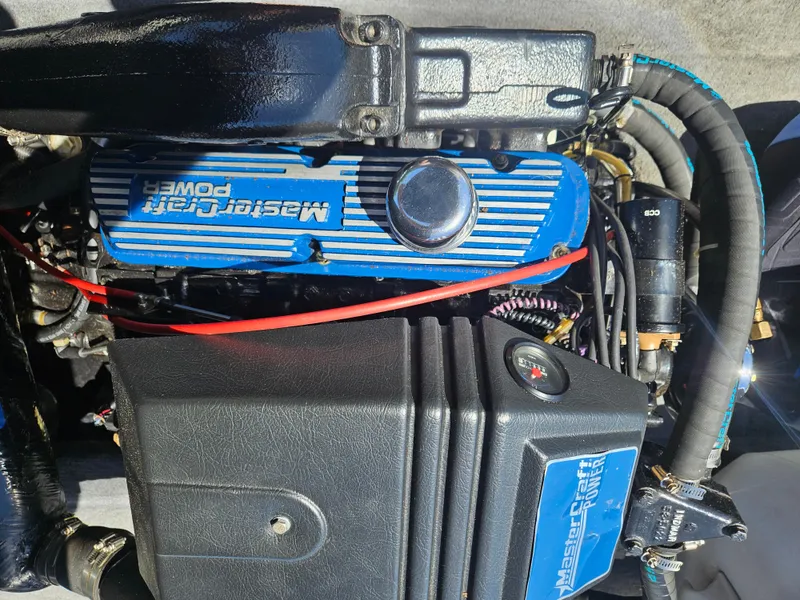 Slide: The Image of 1992 MasterCraft Prostar 205 engine with blue valve cover and visible components. - 11