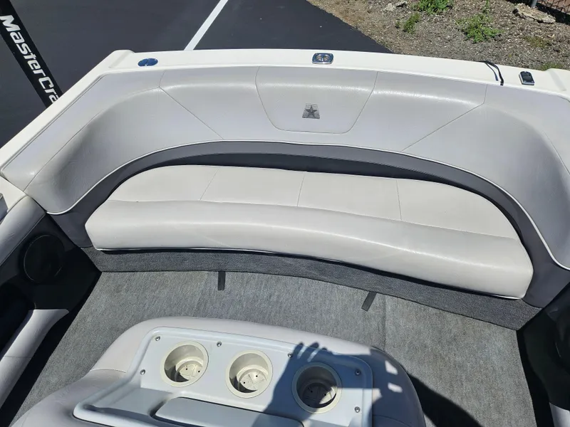 Slide: The Image of Interior of a 1992 MasterCraft Prostar 205 boat with gray seating and cup holders. - 14