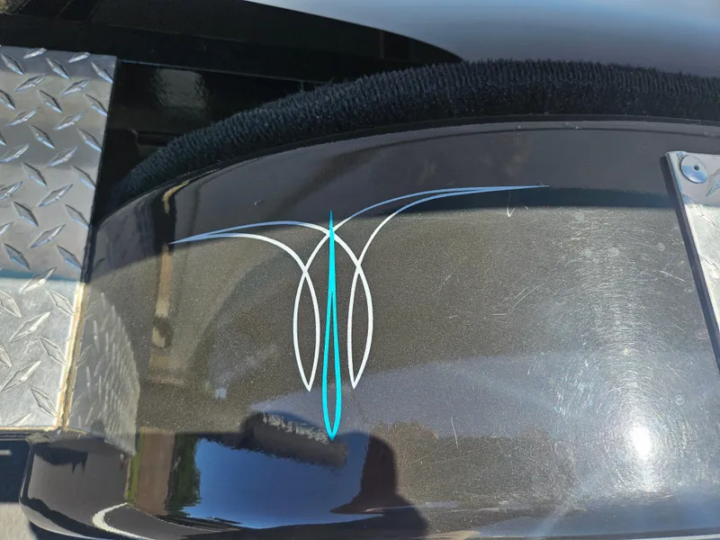 Slide: The Image of 1992 MasterCraft Prostar 205 with custom pinstripe design on black surface. - 16