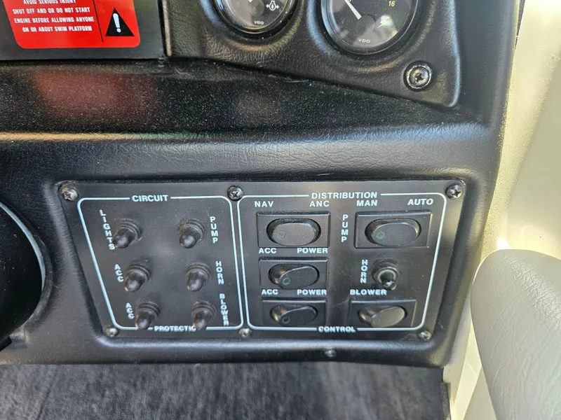 Slide: The Image of Control panel of a 1992 MasterCraft Prostar 205 boat with switches and gauges. - 8