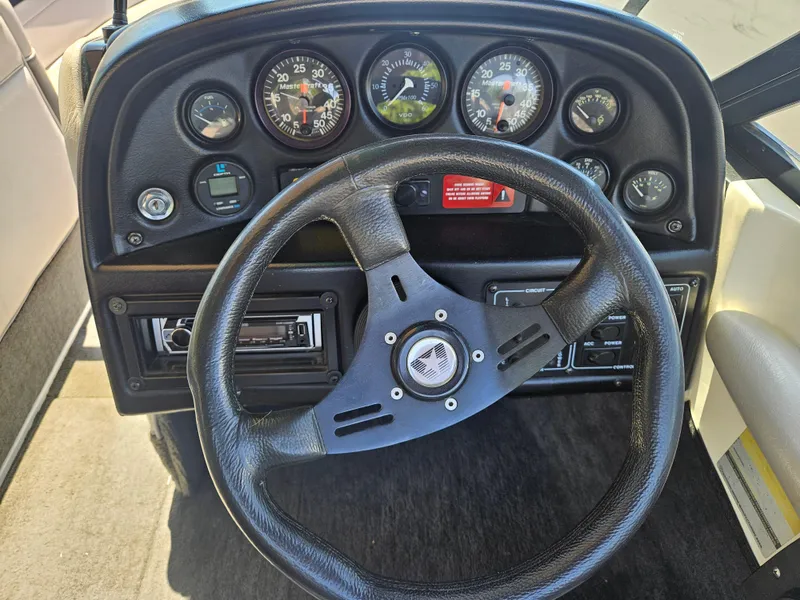 Slide: The Image of 1992 MasterCraft Prostar 205 dashboard with steering wheel and instrument gauges. - 9