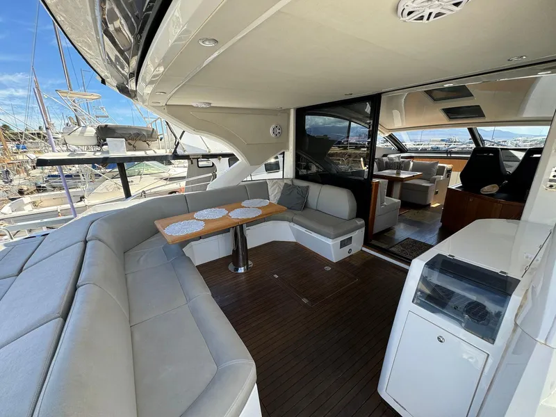 Slide: The Image of 2017 Sunseeker Predator 57 yacht interior with elegant seating and dining area. - 10