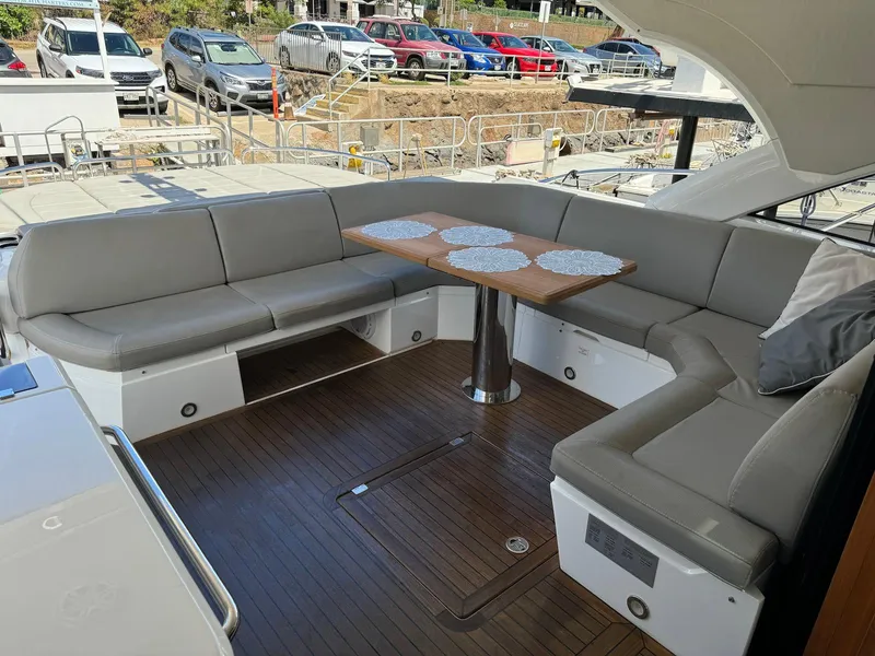 Slide: The Image of Luxurious Sunseeker Predator 57 yacht deck with elegant seating and table, 2017 model. - 11