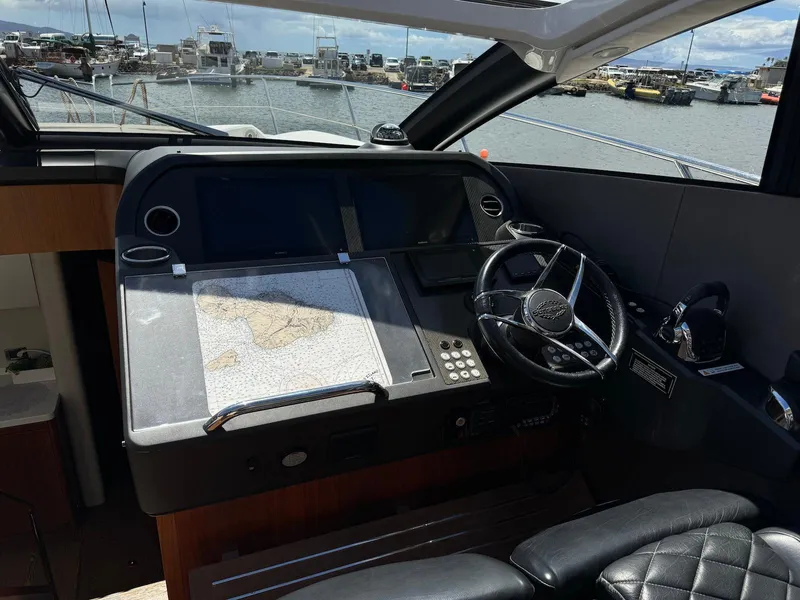 Slide: The Image of 2017 Sunseeker Predator 57 yacht helm with navigation equipment and steering wheel. - 16