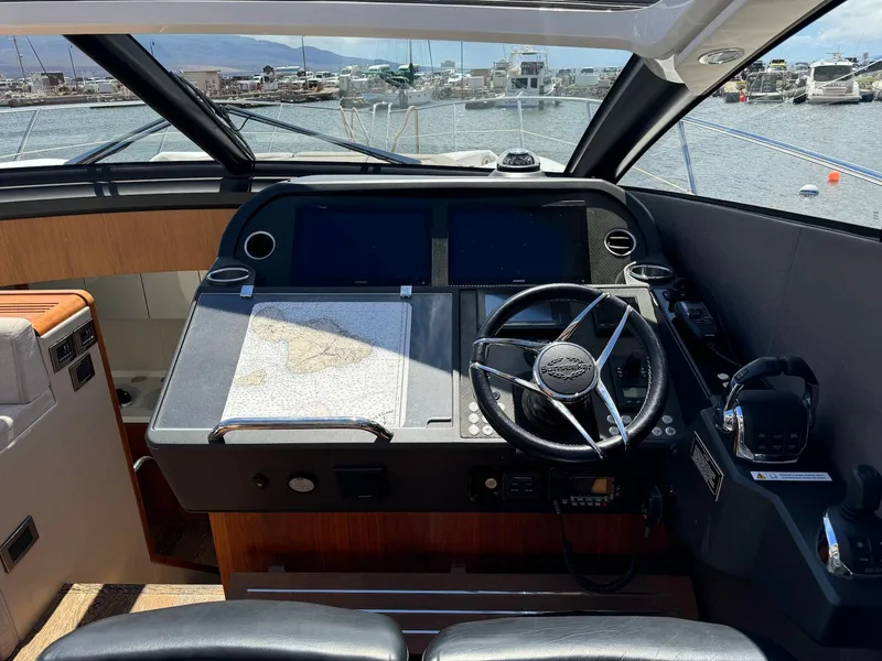 Slide: The Image of Helm of 2017 Sunseeker Predator 57 yacht with steering wheel and navigation equipment. - 17