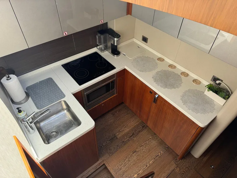 Slide: The Image of Modern kitchen in a 2017 Sunseeker Predator 57 yacht, featuring sleek countertops and appliances. - 18