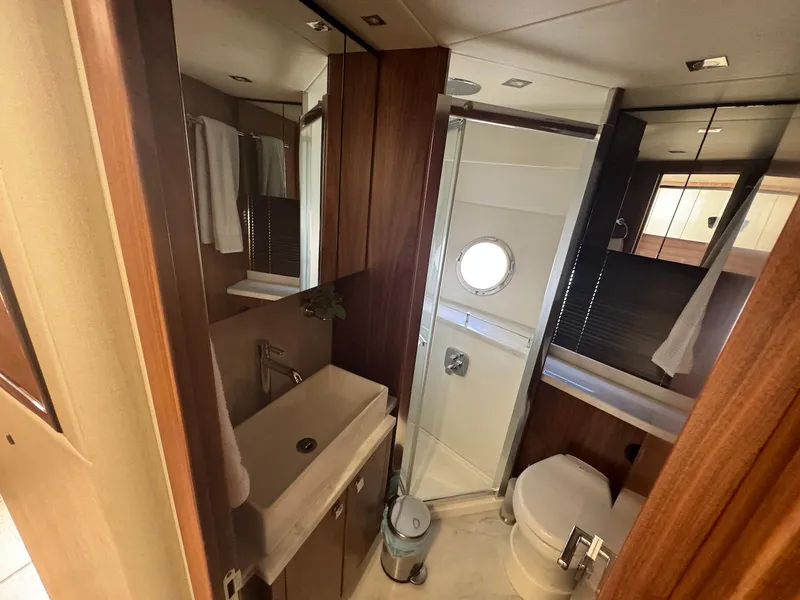 Slide: The Image of Luxurious bathroom in 2017 Sunseeker Predator 57 yacht, featuring modern fixtures and elegant wood finishes. - 22