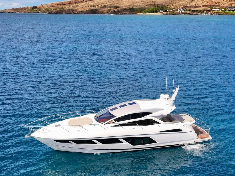 Slide: The Image of 2017 Sunseeker Predator 57 yacht cruising on blue ocean near scenic coastline. - 3