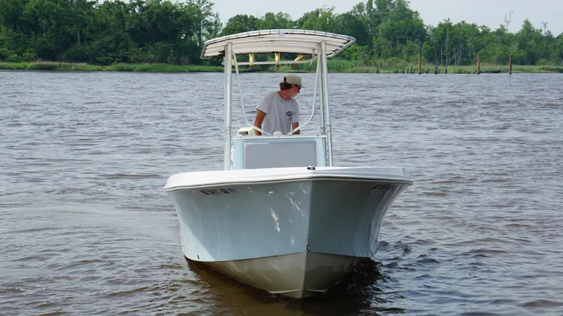 Slide: The Image of Man steering 1998 Sea Ox 20'6" boat on a calm river. - 3