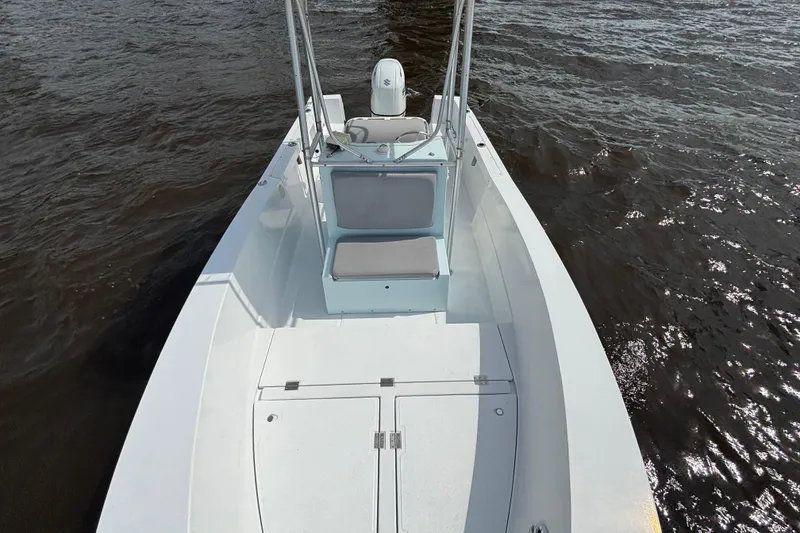 Slide: The Image of 1998 Sea Ox 20'6" boat on water, featuring open deck and seating. - 9