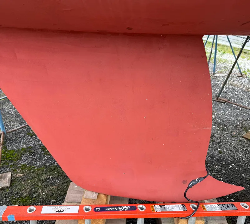 Slide: The Image of Red keel of a 1997 Alerion Express 28 sailboat on a stand. - 5