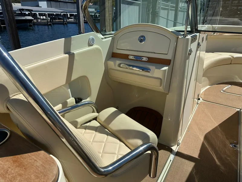 Slide: The Image of 2016 Chris-Craft Launch 28 interior with beige seating and elegant wood accents. - 12