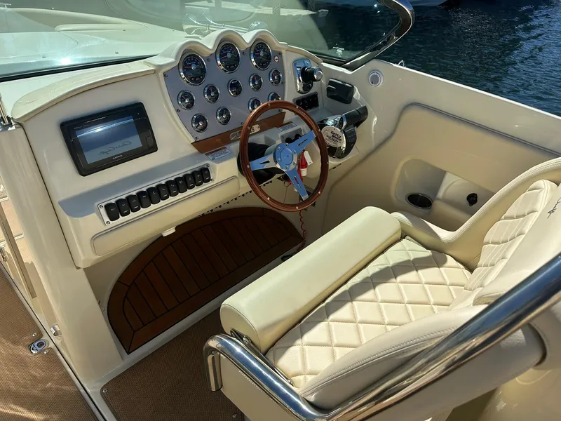 Slide: The Image of 2016 Chris-Craft Launch 28 cockpit with luxurious seating and modern dashboard controls. - 13