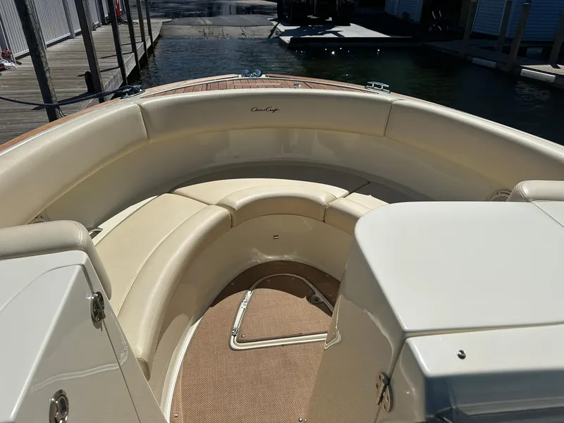 Slide: The Image of 2016 Chris-Craft Launch 28 boat interior with beige seating and wood accents. - 16