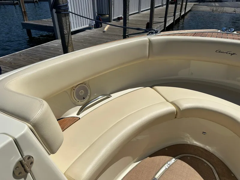 Slide: The Image of 2016 Chris-Craft Launch 28 boat interior with cream leather seating and speaker. - 17