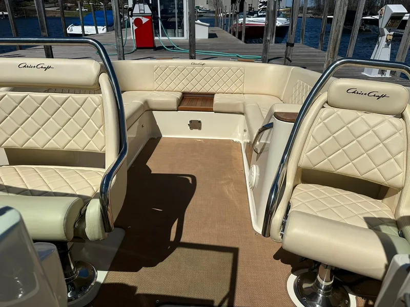Slide: The Image of 2016 Chris-Craft Launch 28 interior with beige quilted seats and chrome accents. - 21