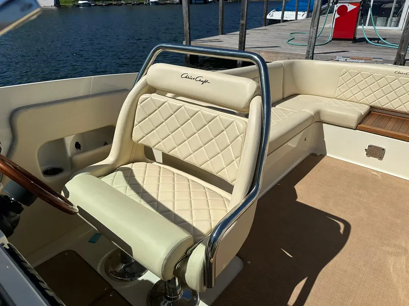 Slide: The Image of 2016 Chris-Craft Launch 28 boat interior with beige leather seating and elegant design. - 22