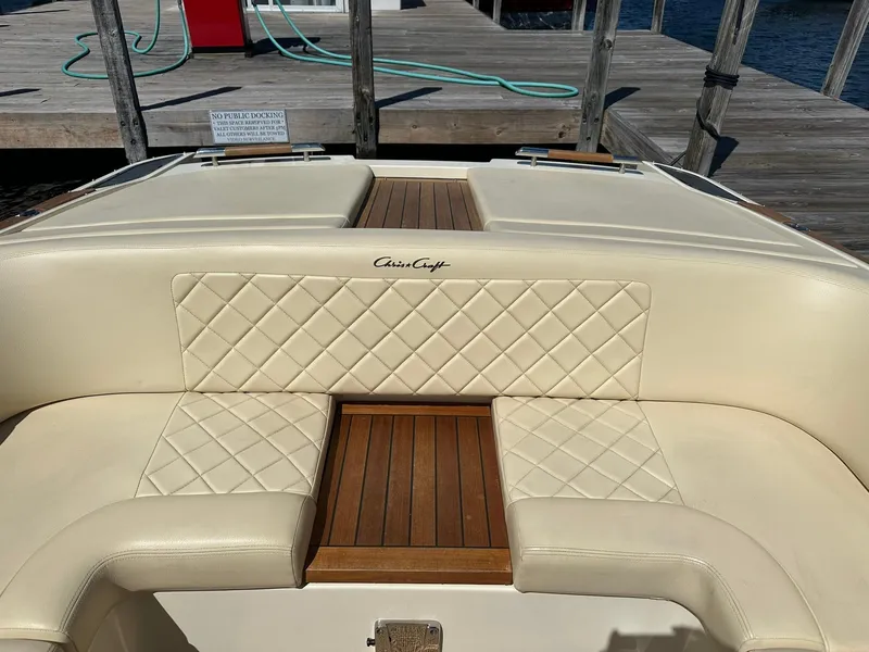 Slide: The Image of 2016 Chris-Craft Launch 28 boat interior with cream quilted seats and wooden accents. - 25