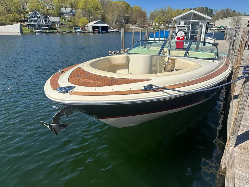 Slide: The Image of 2016 Chris-Craft Launch 28 docked on a serene lake with scenic background. - 4