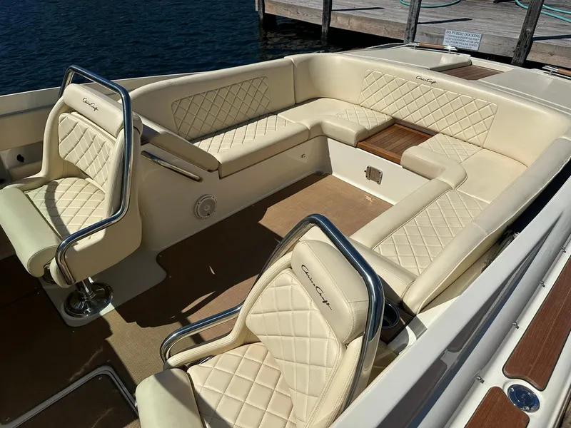 Slide: The Image of 2016 Chris-Craft Launch 28 boat interior with beige quilted seating and wood accents. - 5