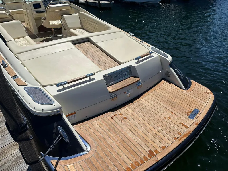 Slide: The Image of 2016 Chris-Craft Launch 28 boat with teak deck, docked on calm water. - 6