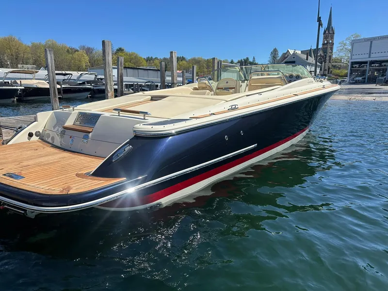 Slide: The Image of 2016 Chris-Craft Launch 28 boat docked in a marina, featuring sleek design and luxurious interior. - 7